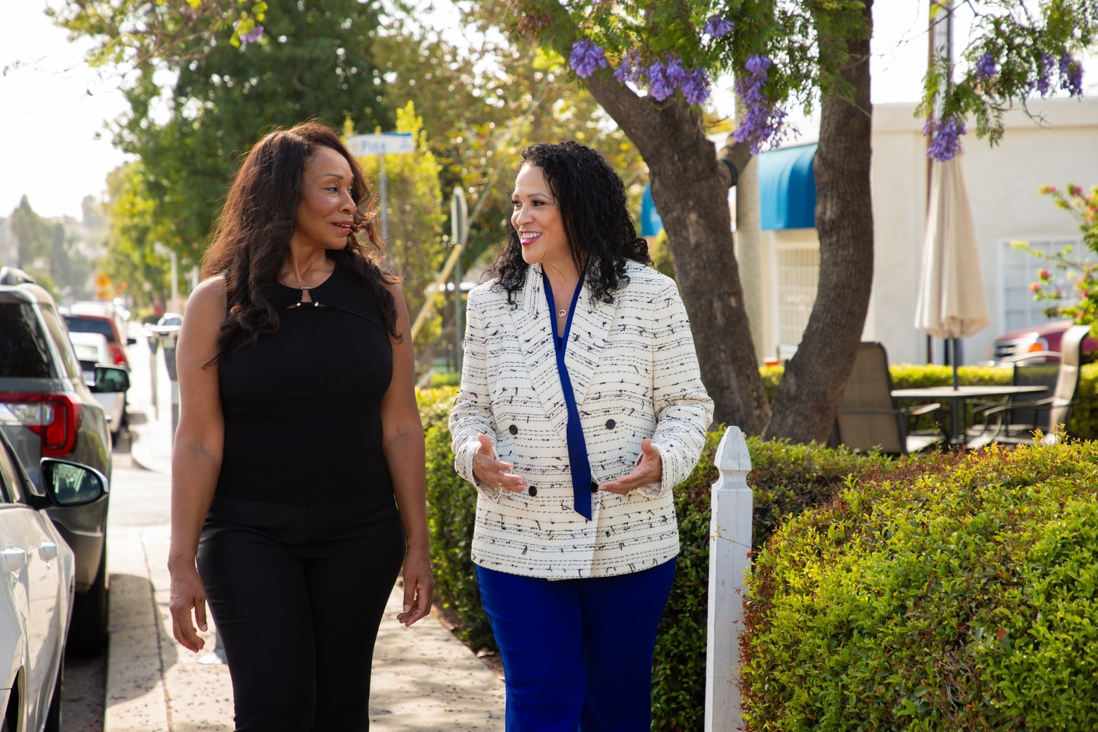 Patricia Dillard walking and talking with a neighbor in downtown La Mesa
